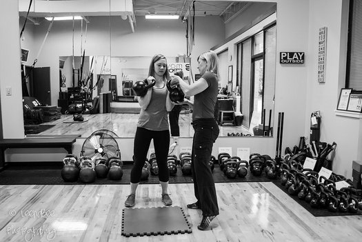 RKC Team Leader Lori Crock Coaching a client with double kettlebells