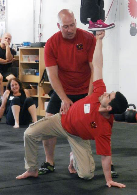 Ryan Jankowitz, RKC-II and Master RKC Michael Krivka demonstrate the get-up at a recent HKC workshop in Gathersburg, MD.