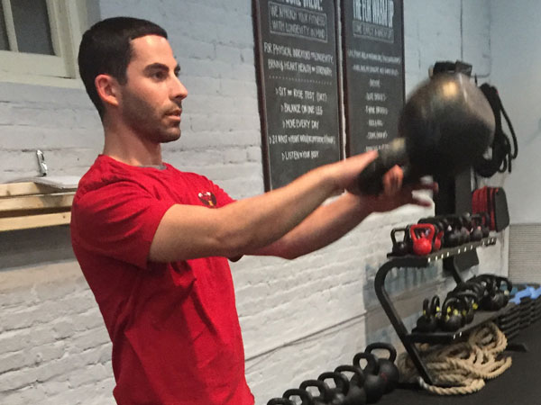 Ryan Jankowitz easily switches hands at the top of a one arm kettlebell swing during the "float"