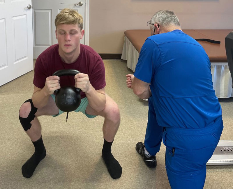 Paul Britt instructing the goblet squat at his clinic